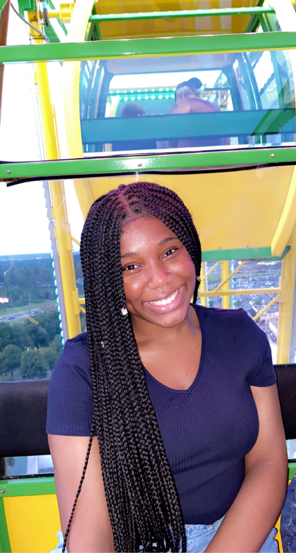 Esther smiling on a ferris wheel