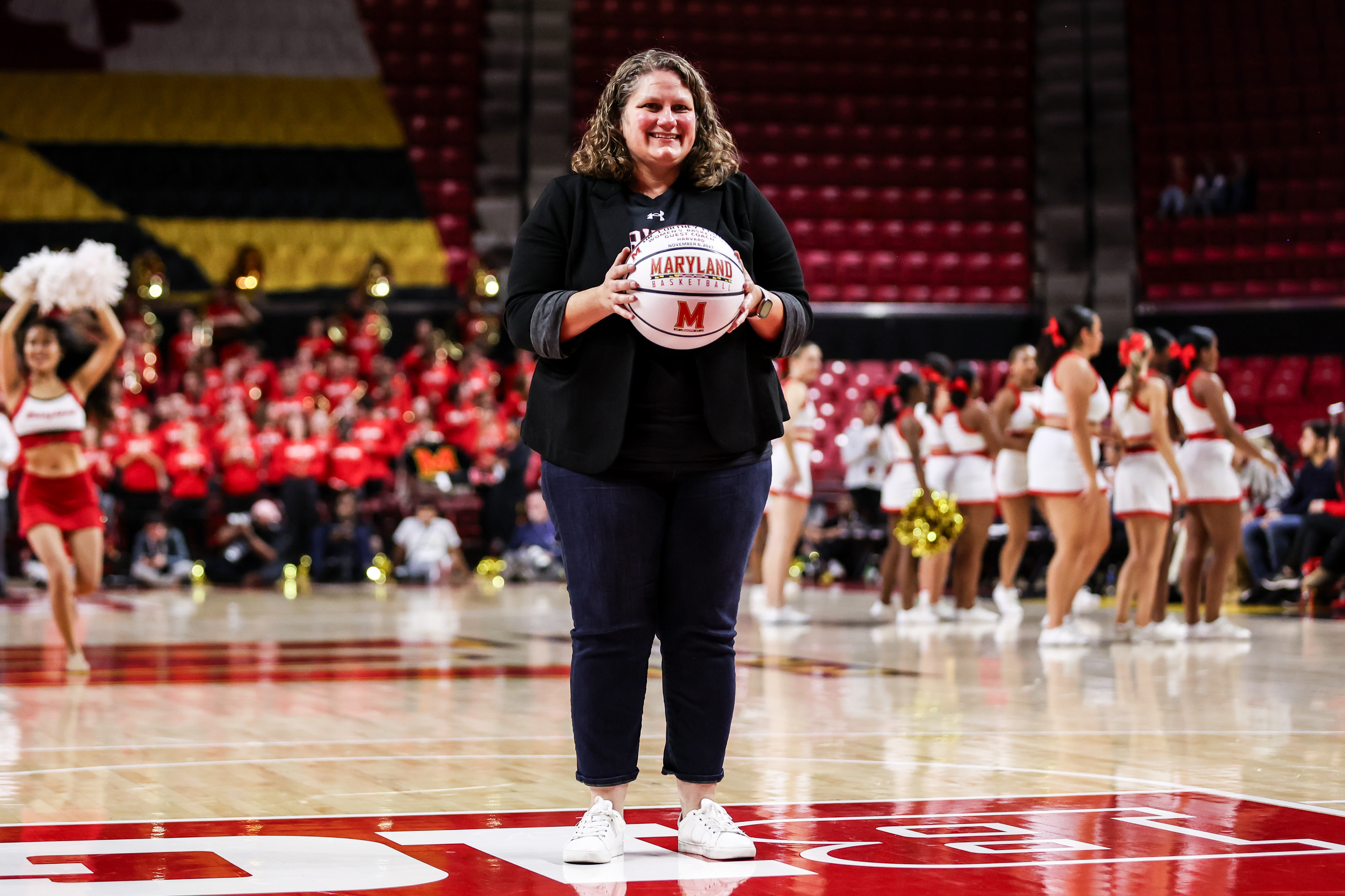 photo of Cortney Fisher being recognized as the guest coach of the Maryland Women's Basketball game against Harvard