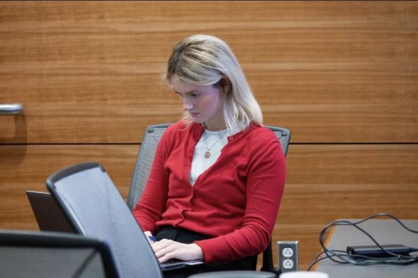 Grace Hayden working on a laptop in her new professional attire