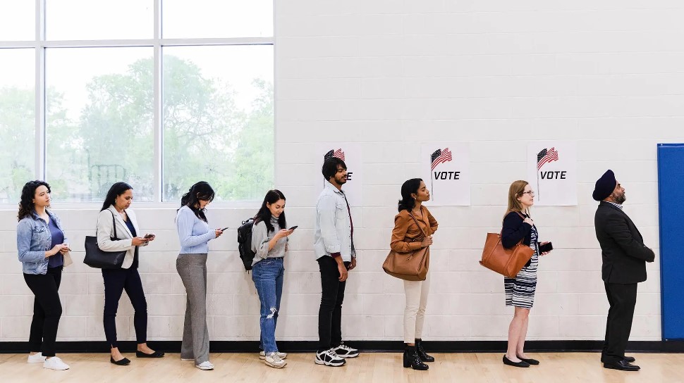 photo of voters waiting in line to cast their votes