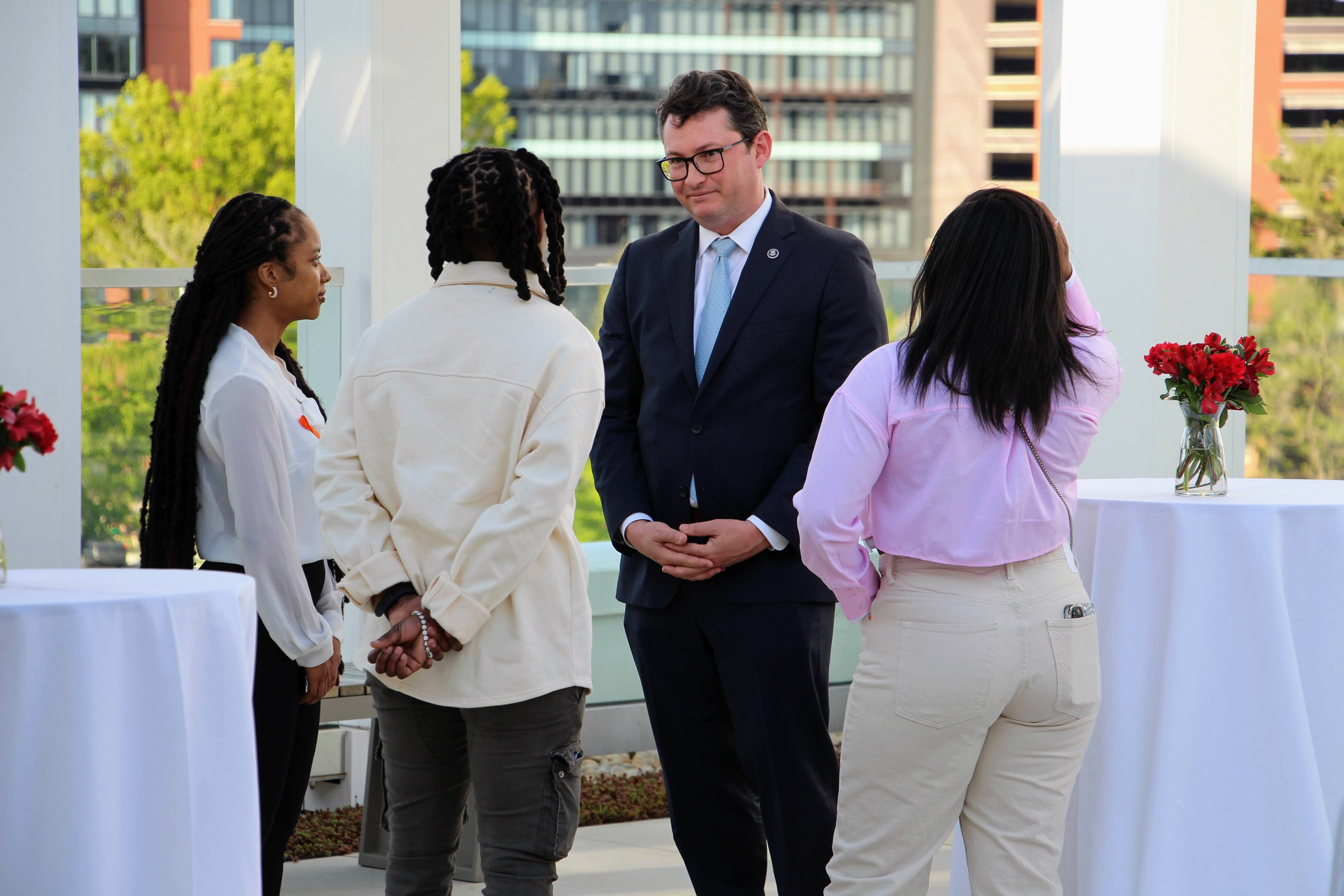 Rob Wilcox, Deputy Director of the WHOGVP, confers with gun violence survivors.