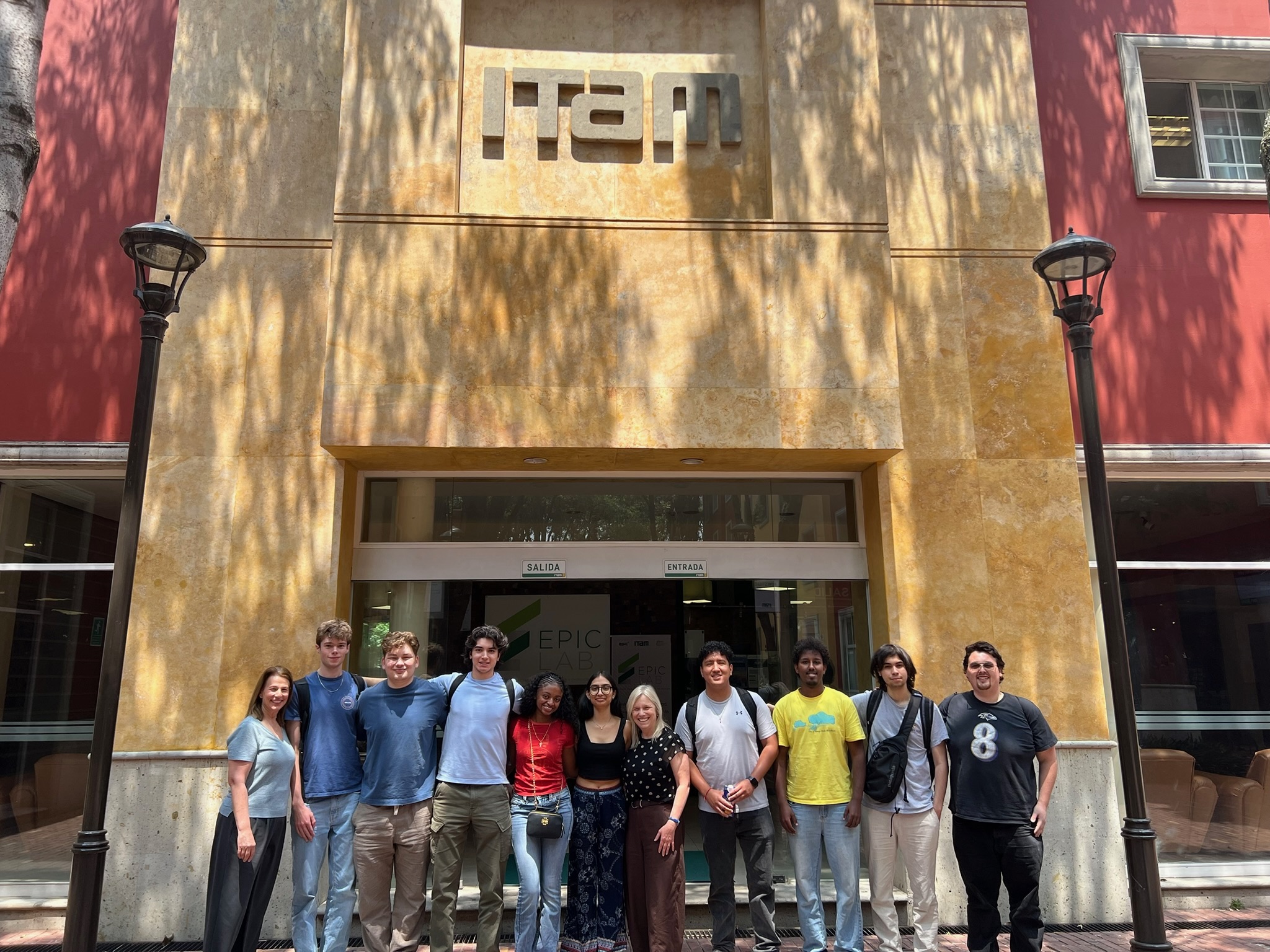 group photo of the students who went on the UMD Department of Economics' first study abroad trip to Mexico, standing in front of a building with "ITAM" written on the top