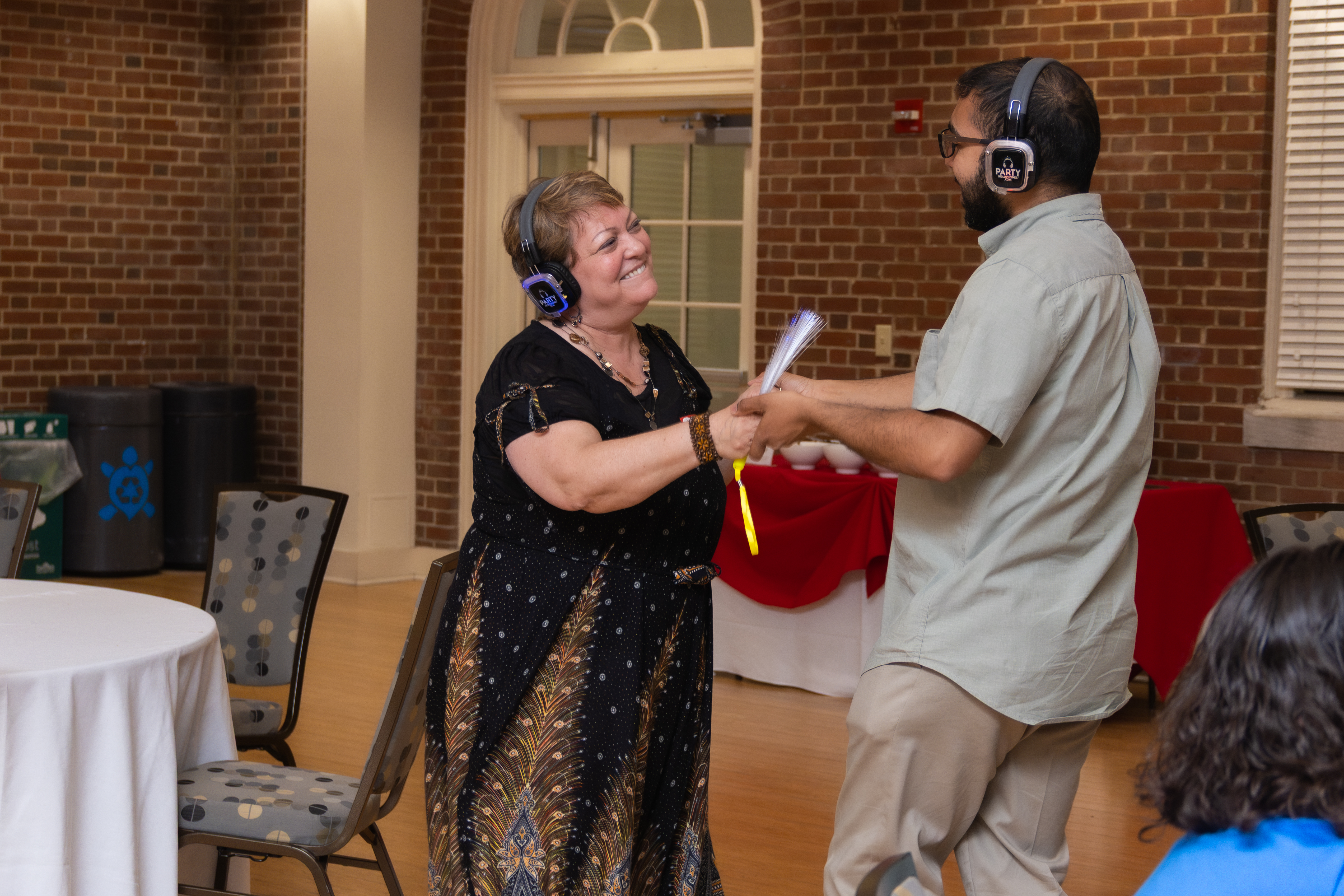 Kathy Dow-Burger (left) dancing with an attendee of SIGNA's 10th Anniversary event during the silent disco