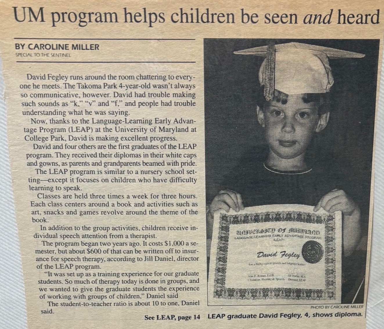 Newspaper clipping that has a balck and white photo of David Fegley holding up a graduating certificate from the UMD LEAP preschool