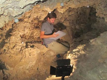 Image of Matt Reilly in cave for field work