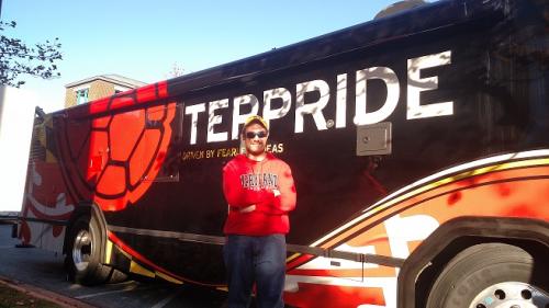 Junior Tyler Ziegler stands in front of the Terpride bus.