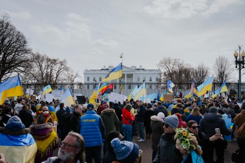 Americans with Ukraine flags standing outside the White House