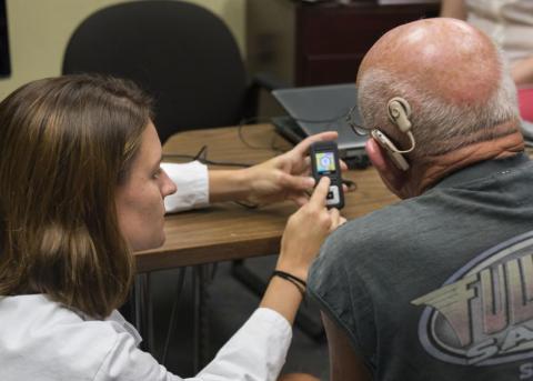 HESP Clinician looks inside a patient's ear.