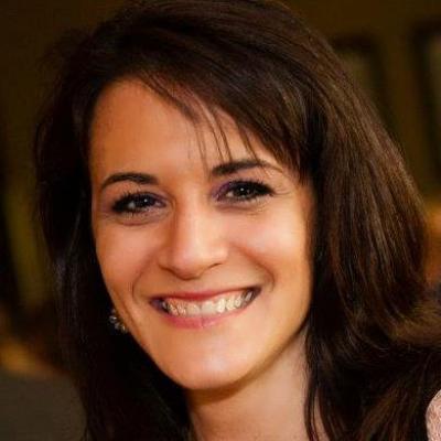headshot photo of Lisa Wiederlight, an alumna of the University of Maryland, who has shoulder-length brown hair with bangs and is smiling at the camera