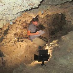 Image of Matt Reilly in cave for field work